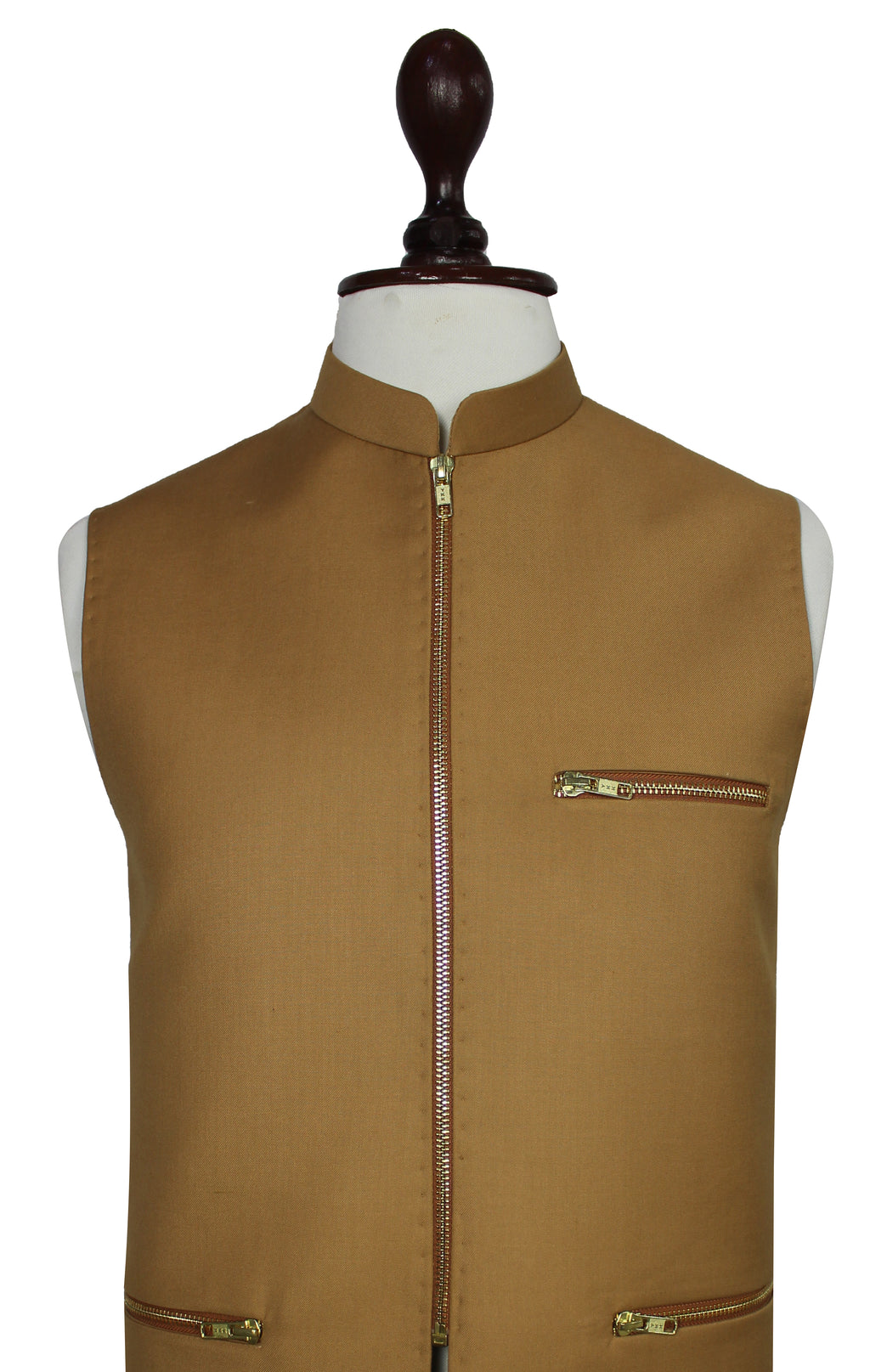 A sleeveless tan waistcoat displayed on a mannequin torso against a white background. The vest features a mandarin collar, a central front zipper, a zippered chest pocket, and zippered hand pockets near the hem.