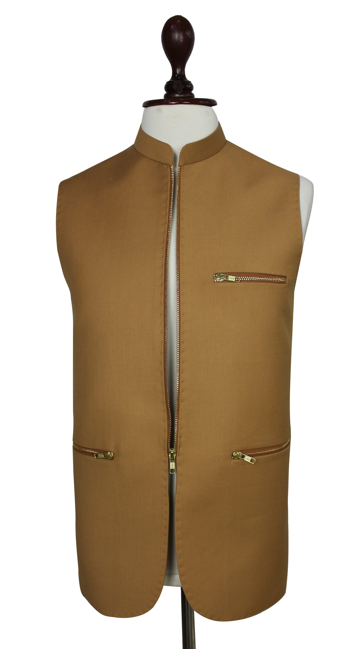 A tan waistcoat displayed on a white mannequin torso against a plain white background. The waistcoat features a mandarin collar, a front zipper closure, a zippered chest pocket, and two zippered lower pockets with gold-toned hardware.