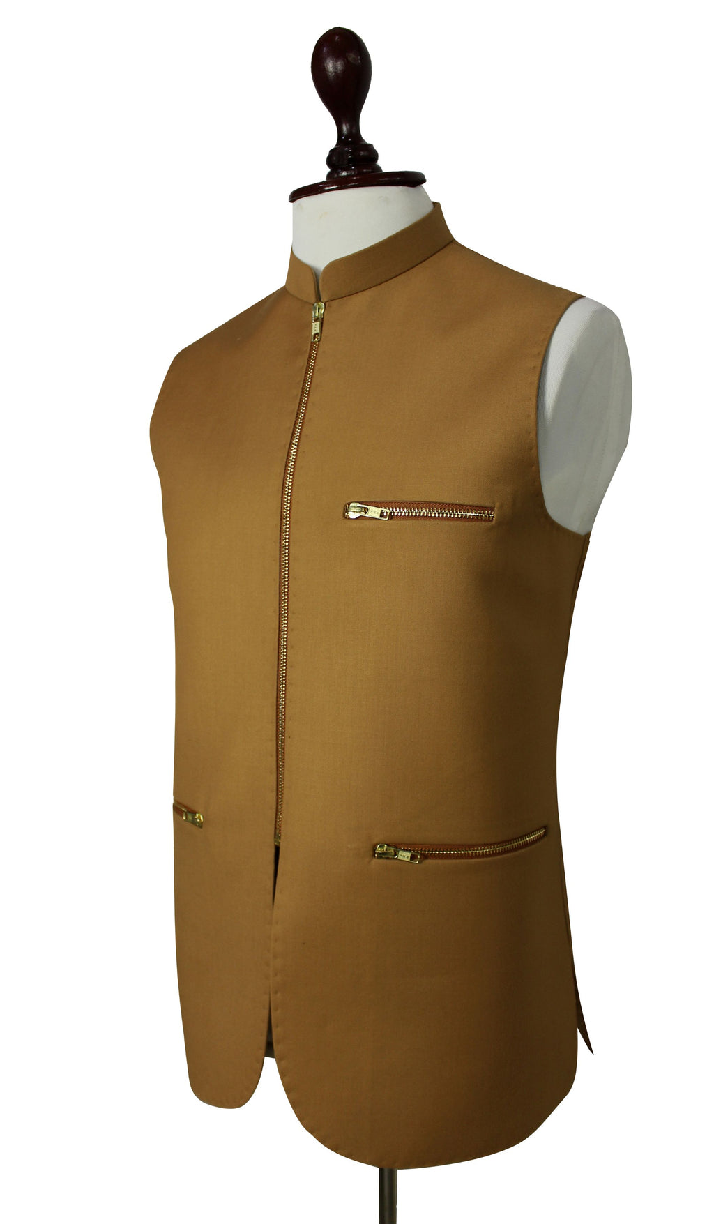 A sleeveless tan waistcoat vest displayed on a white mannequin torso with a dark wooden neck cap, featuring a front zipper, zippered chest pocket, and zippered lower pocket.