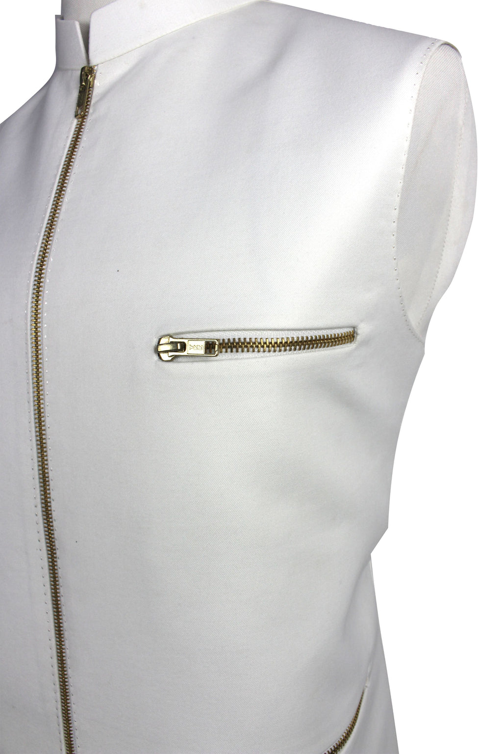 A close-up of a white sleeveless vest or jacket with gold-tone zippers, including a front zipper and a horizontal zip pocket on the chest.